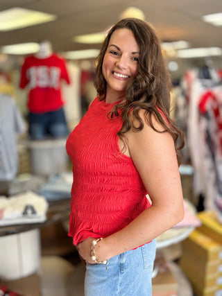 Model wearing red smocked tank top