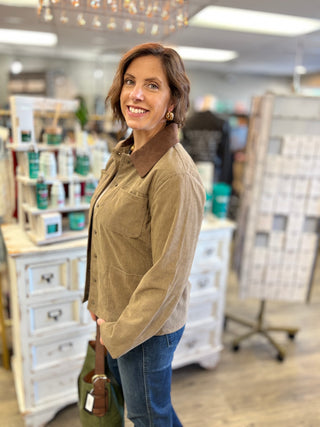 Side view of the taupe Hay There corduroy barn jacket showing its slightly oversized fit, long sleeves and medium length