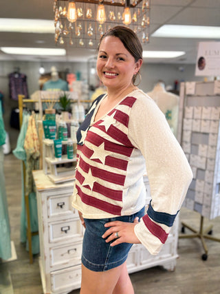 Woman wearing a star-patterned top in a store setting