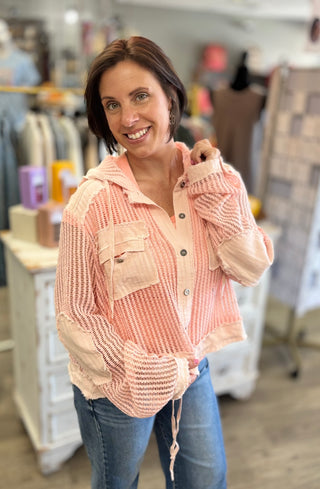 Model wearing peach color top with mesh, button and tie string detail