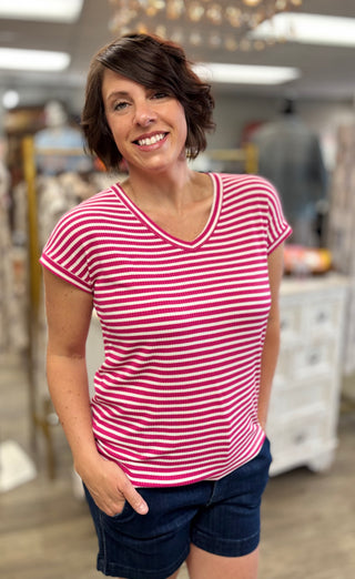 Model wearing fuchsia and white striped top 
