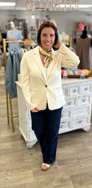 Model wearing ecru blazer with scarf accessory