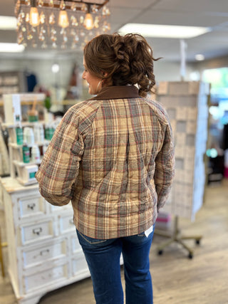 Model wearing a multi brown plaid quilted barn jacket with corduroy collar details.